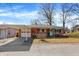 Charming brick home features a covered carport, landscaped front yard, and a bright blue front door at 230 N School St, Fortville, IN 46040