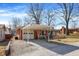 Brick ranch-style home with covered carport and driveway leading to an attached garage at 230 N School St, Fortville, IN 46040