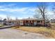 Quaint brick home has a covered carport with an attached garage and small front garden at 230 N School St, Fortville, IN 46040