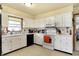 Functional kitchen with white cabinets, offering ample storage and counter space at 230 N School St, Fortville, IN 46040
