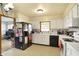 Bright kitchen with white cabinets, black appliances, and a practical layout for cooking at 230 N School St, Fortville, IN 46040