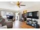 Spacious living room with hardwood floors, ceiling fan, and views of the front yard at 230 N School St, Fortville, IN 46040