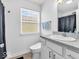 Bright bathroom features a modern vanity, toilet, and window at 251 Hendricks Pl, Indianapolis, IN 46201