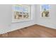 Bright bedroom with two large windows providing ample natural light and wood flooring at 251 Hendricks Pl, Indianapolis, IN 46201