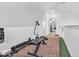 Home exercise room with weight bench, golf putting area, and neutral carpeting at 251 Hendricks Pl, Indianapolis, IN 46201