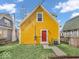 Charming yellow house featuring a red door and well-maintained landscaping at 251 Hendricks Pl, Indianapolis, IN 46201