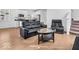 Open-concept living room and kitchen featuring hardwood floors and modern appliances at 251 Hendricks Pl, Indianapolis, IN 46201