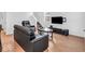 Cozy living room featuring hardwood floors, TV, staircase, and modern décor at 251 Hendricks Pl, Indianapolis, IN 46201