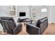 Inviting living room with hardwood floors, TV, and bright natural light from large windows at 251 Hendricks Pl, Indianapolis, IN 46201