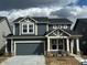 Two-story home with a two-car garage, neutral trim, and newly planted landscaping at 2777 Penn Ave, Plainfield, IN 46168