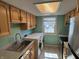 Functional laundry room with stainless steel appliances, cabinets, and a window at 2826 Country Estates Dr, Indianapolis, IN 46227