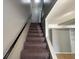 Carpeted staircase leading to the upper level with a dark handrail at 2826 Country Estates Dr, Indianapolis, IN 46227