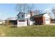 Grassy backyard featuring the home, garage, and screened-in porch at 3300 Heritage Rd, Columbus, IN 47203