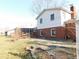 Grassy backyard featuring the home, and screened-in porch at 3300 Heritage Rd, Columbus, IN 47203