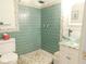 The bathroom features a glass vessel sink and a walk-in shower with blue tiling and river rock accents at 3300 Heritage Rd, Columbus, IN 47203