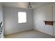 A bright and airy bedroom featuring light-colored walls, carpet, and a ceiling fan with lighting at 3300 Heritage Rd, Columbus, IN 47203