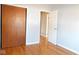 Bright bedroom with wood floor and door to another room at 3300 Heritage Rd, Columbus, IN 47203