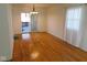 Open-concept dining room with hardwood floors and sliding glass doors to backyard at 3300 Heritage Rd, Columbus, IN 47203