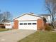 Spacious two car attached garage with brick facade and ample parking space at 3300 Heritage Rd, Columbus, IN 47203