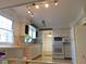 Bright kitchen with white cabinets, appliances, and breakfast bar at 3300 Heritage Rd, Columbus, IN 47203
