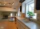 A view of kitchen sink and white cabinets with a view of the living area beyond at 3300 Heritage Rd, Columbus, IN 47203