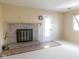 Comfortable living room features brick fireplace and large front-facing window at 3300 Heritage Rd, Columbus, IN 47203