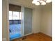 View of a wooden porch and an outdoor area through a sliding glass door at 3300 Heritage Rd, Columbus, IN 47203