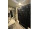 Functional bathroom featuring a pedestal sink, and a shower with a stylish black ruffled shower curtain at 340 N Eaton Ave, Indianapolis, IN 46219