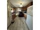 Compact kitchen featuring wooden cabinetry and standard appliances, providing a functional cooking space at 340 N Eaton Ave, Indianapolis, IN 46219