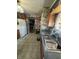 Functional kitchen with wood cabinets, white appliances, and worn tile flooring, ready for updates at 340 N Eaton Ave, Indianapolis, IN 46219