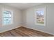 Cozy bedroom with two windows providing natural light and wood-look flooring at 3505 Ralston Ave, Indianapolis, IN 46218