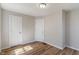 Spacious bedroom with neutral walls, two doors, and wood-look flooring at 3505 Ralston Ave, Indianapolis, IN 46218