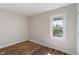 Bright bedroom featuring a window providing natural light and wood-look flooring at 3505 Ralston Ave, Indianapolis, IN 46218