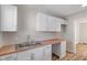 Modern kitchen featuring white cabinets, butcher block countertops, stainless steel sink, and ample counter space at 3505 Ralston Ave, Indianapolis, IN 46218