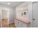 Cozy kitchen pass through with white cabinets, butcher block countertops, and wood-look flooring at 3505 Ralston Ave, Indianapolis, IN 46218