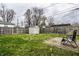 Fenced backyard with a storage shed, green grass, and an outdoor seating area on a stone paver patio at 3867 Asbury St, Indianapolis, IN 46227