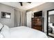 Cozy bedroom with natural light, featuring neutral gray walls, light carpet, and sleek dark wood furniture at 3867 Asbury St, Indianapolis, IN 46227