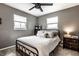 This bedroom has neutral walls, two windows that let in plenty of natural light, and a ceiling fan at 3867 Asbury St, Indianapolis, IN 46227