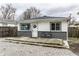 Charming single-story home featuring a well-kept yard and inviting front porch with modern colors at 3867 Asbury St, Indianapolis, IN 46227