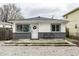 Charming single-story home featuring a well-kept yard and inviting front porch with modern colors at 3867 Asbury St, Indianapolis, IN 46227
