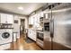 Updated kitchen with stainless steel appliances, white cabinetry, and modern countertops in a cozy home at 3867 Asbury St, Indianapolis, IN 46227