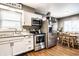 Modern kitchen with stainless steel appliances, including a refrigerator, oven, and microwave, plus a view to dining area at 3867 Asbury St, Indianapolis, IN 46227