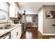 The kitchen has stainless steel appliances and white cabinetry, which is adjacent to the dining area at 3867 Asbury St, Indianapolis, IN 46227