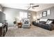 Spacious living room featuring plush seating, a ceiling fan, and cozy decor, creating a comfortable place to relax at 3867 Asbury St, Indianapolis, IN 46227