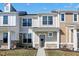 Charming new two-story townhouse with stone accents and a well-maintained lawn under a bright blue sky at 3923 Wren Dr, Brownsburg, IN 46112