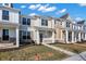 Row of charming townhouses with varied designs, inviting porches, and neat landscaping under a partly cloudy sky at 3923 Wren Dr, Brownsburg, IN 46112