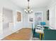 Bright dining room with a modern chandelier, an open view to the living room, and a cheerful atmosphere for gatherings at 411 W Memorial Dr, Muncie, IN 47302