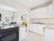 Open-concept kitchen with white cabinets, granite countertops, and a clear view into the adjacent living and dining spaces at 411 W Memorial Dr, Muncie, IN 47302