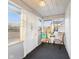 Bright sunroom with lots of windows, neutral chairs, and a cozy atmosphere at 411 W Memorial Dr, Muncie, IN 47302