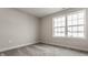 Neutral bedroom featuring carpeted floors, base trim, and white trimmed windows at 452 S Meridian St # B Bldg D, Greenwood, IN 46142